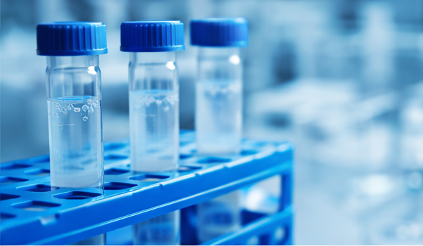 cGMP peptide manufacturing clean room with gowned technicians operating equipment